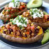 Cut sweet potatoes topped with guacamole and a dollop of sour cream.